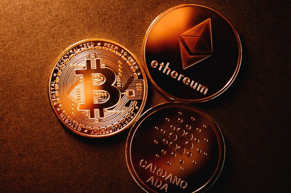 loan against crypto. Close-up of Bitcoin, Ethereum, and Cardano coins
