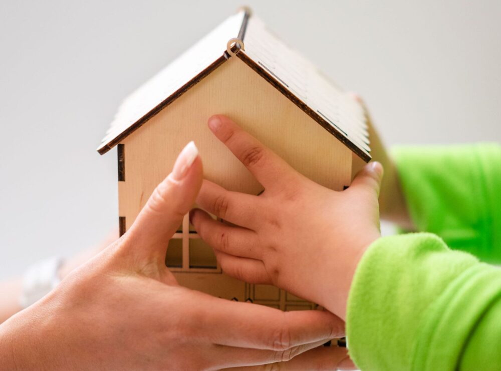 loans against inheritance. mother handing child wooden home